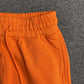 DENIM TEARS COTTON WREATH SWEATPANTS ORANGE