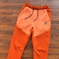 NIKE TECH FLEECE PANTS x CAMPFIRE ORANGE