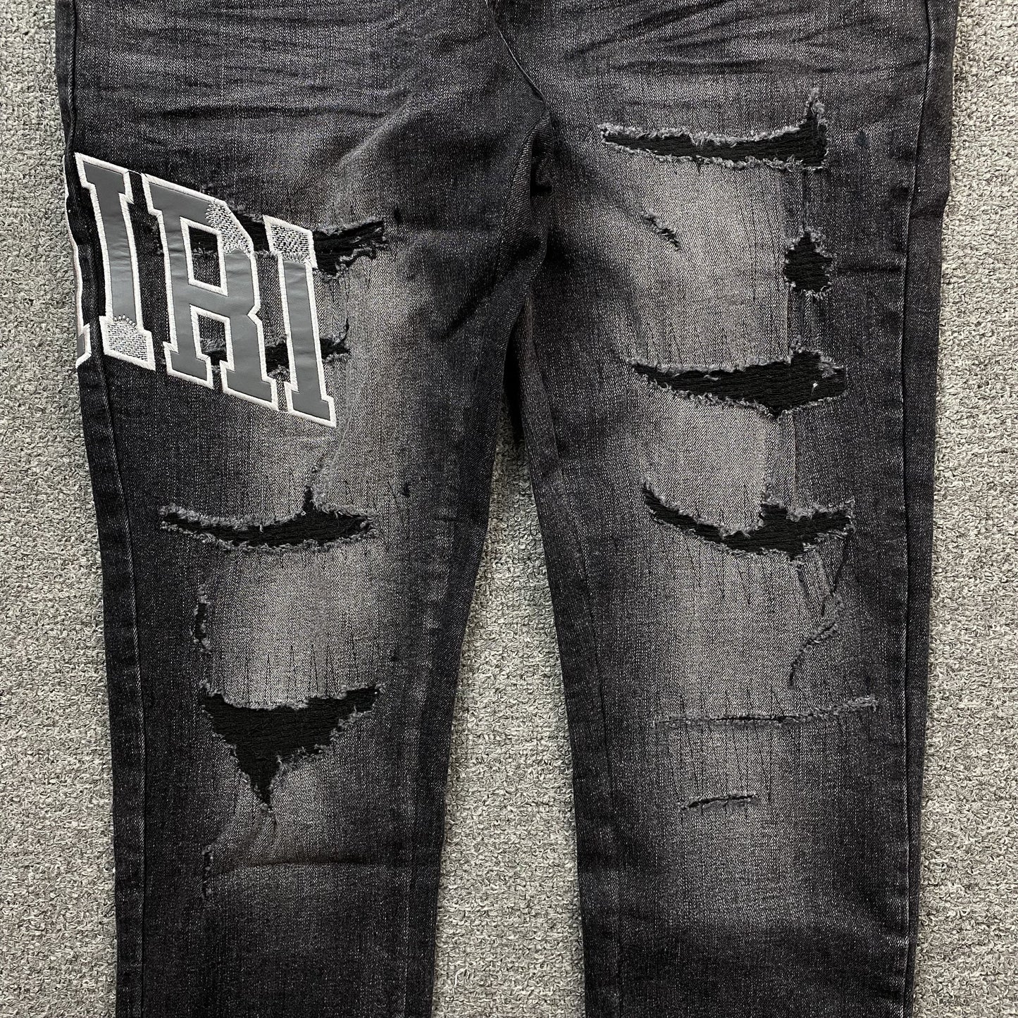 AMIRI VARSITY LOGO REPAIR JEANS